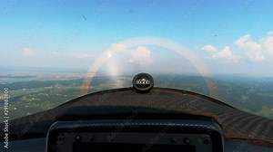 Pilots view flying a small propeller airplane, magnetic compass on dashboard, cross country flying concept, freedom above the clouds