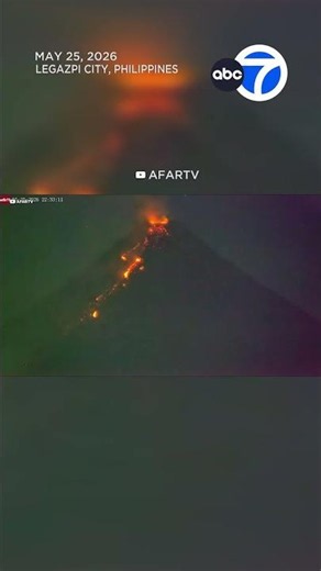 Meteor streaks past erupting volcano