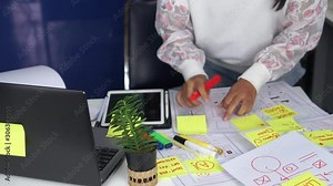 Web designer planning mobile application content of prototype on document design software ux architect on table office. Developer creative display production on user interface project technology. 4k