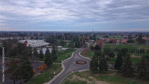 Drone perspectives show the California State Stanislaus University campus as evening settles in, with overcast skies, subdued colors, and campus structures framed by gentle twilight.