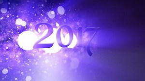 Violet magic 2017 New Year seamless loop video title with cinematic rays and snow bokeh depth of field effect. The holiday is coming.