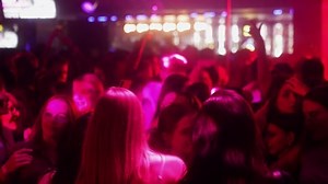 Belarus, Minsk - November 19, 2022: Young people having fun and dancing at a night party in a club, multicolored light, crowd, 4k Slow motion.