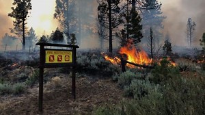 California fires advance as heat wave covers West
