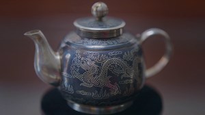 Silver-inlaid black copper, an ancient handicraft, is one of China's national intangible cultural heritages. It requires a complicated process, using black copper as the roughcast, then inlaying melted silver (or gold) into the nicks to create artistic patterns. After a high temperature fuses the two metals into one, technical treatments, including cooling, grinding and polishing, turn it into an exquisite artwork with a unique style. #chinaintangibleculturalheritage #yunnan #silver #copper #han