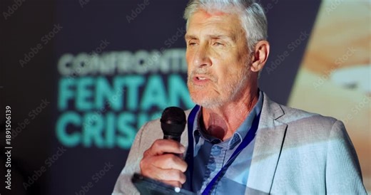 Tablet, stage and man with mic, speaker and serious for fentanyl crisis, healthcare and event. Explaining, presentation and public speaking in seminar, communication and mature person in workshop
