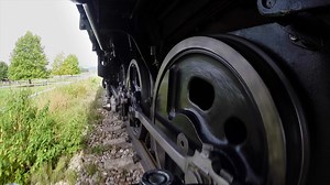 Historical steam engine train locomotive crossing railroad tracks