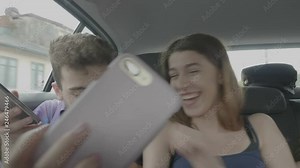 Funny teenage woman pinching nipple of her boyfriend inside a riding car