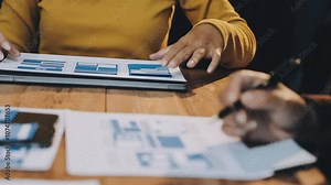 Web design process. The web designer creating a mockup of the mobile application according to the customer's brief. Samples and sketches laying at the table