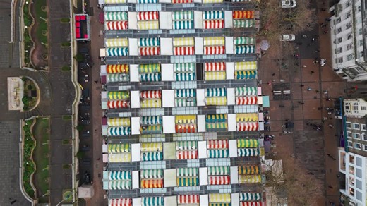 Colorful market stalls in Norwich, Norfolk, viewed from above, vibrant and lively scene | Premium Stock Video Footage
