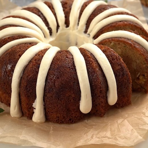 20K views · 502 reactions | Who needs to buy a fancy bundt cake when you can make one yourself? This Zucchini Cake is packed with zucchini, pineapple, and coconut and topped with a tangy cream cheese frosting. It'll be love at first bite! Zucchini Cake >>> https://www.mybakingaddiction.com/zucchini-cake/ | My Baking Addiction | Facebook