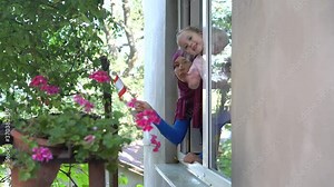 Beirut, Lebanon. An Arab Muslim woman with her child with the flag of Lebanon. Lebanese protests