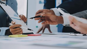 Download Group of coworkers in formal wear sitting at table in conference room and arguing about project of company development during meeting for free
