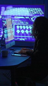 A person working on a computer with advanced graphics represents the possibilities of technology