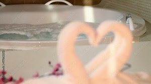 Romantic setting in a private room with jacuzzi and heart shaped towel