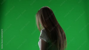Medium green screen, chroma key video of a posessed female, woman figure, ghost, poltergeist, zombie turning her face to the camera with a dead look. Chroma key.
