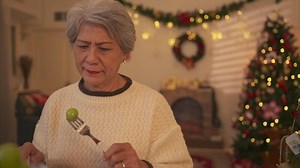 Elderly woman and lonely moments in Christmas night