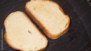 top view of frying bread toasts in the pan, the process of cooking fast snack, breakfast or lunch.