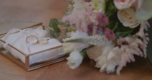 Wedding Rings in Decorated Box with flower background.
