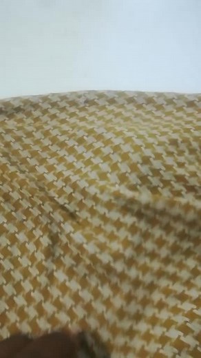 Houndstooth Fabric and Arabic Script Book Close-Up