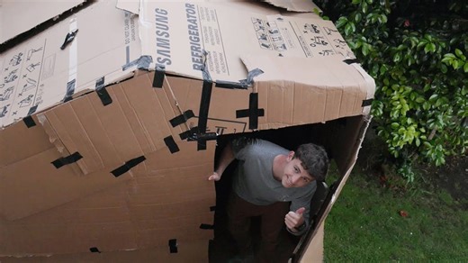 Watch man build a cardboard house and sleep in it overnight