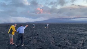 Spectators look on as Hawaii's Mauna Loa erupts