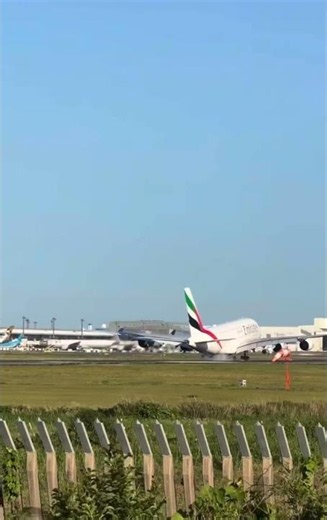 Emirates Airbus A380-800 landing, a distinctive double-deck fuselage and 4-engine configuration.