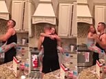 Father & daughter slow dance in kitchen while cooking dinner