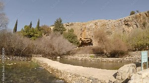Tourists visit archaeological site of cave of Greek god pan, in Hermon Stream Nature Reserve, also known as Banyas, Golan, Israel