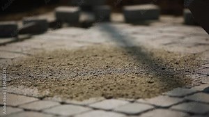 Stone Pavement Road Construction Workers. Applying Polymeric Jointing Sand