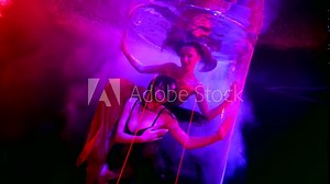 two graceful women floating in depth of pool or aquarium, seductive female bodies