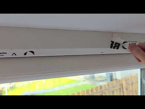 Removing the protective plastic from a new PVC window