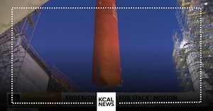 The massive external space shuttle tank moves into the Endeavour's permanent "Go For Stack" position