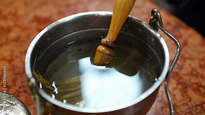 Bowl with Holy water for Sanctification on table in church Cathedral of St. Clement. in Prague, Czech republic