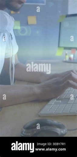 Vertical video: Man typing at desk after prompt, reviewing code to debug as animated charts rising. Workspace, coding, monitor, focus, analytics, modern, vertical video Stock Video Footage - Alamy