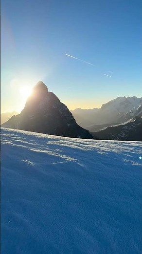 Alpinist on Snowy Ridge sun rising behind Matterhorn 🌄