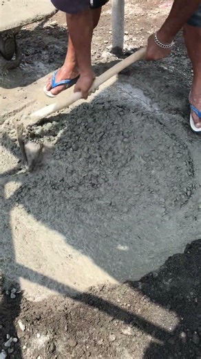 Traditional construction methods: mixing concrete by hand.