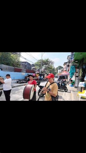 Filipino Christmas caroling (pangangaroling) traditionally involves children singing carols house-to-house, using makeshift instruments like tin-can drums, bottle-cap tambourines, and sometimes flutes, while brass bands with trumpets and drums also play festive tunes, especially in organized groups or events, bringing holiday cheer and receiving aguinaldo (gifts) in return, a tradition blending Spanish influence with local ingenuity. #christmascaroling2025 | Rafael Lloyd Uban Tan