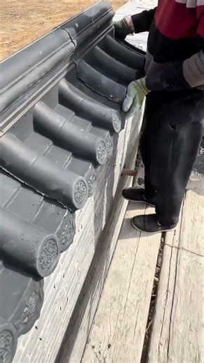 process of installing grey clay roof tiles by hand to ensure a neat and waterproof finish