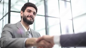 Two diverse professional business men executive leaders shaking hands at office meeting