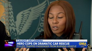 Cops describe rescuing man from a burning car