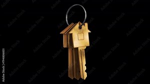 Real Estate Keys. A bunch of three keys in the shape of a house swings on a ring. Looped video with alpha channel.