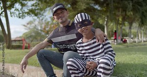 An Asian security guard in a park unexpectedly hilariously encounters an elementary school-aged dressed in a black mask thief. So he asked to take a video together as a memorial