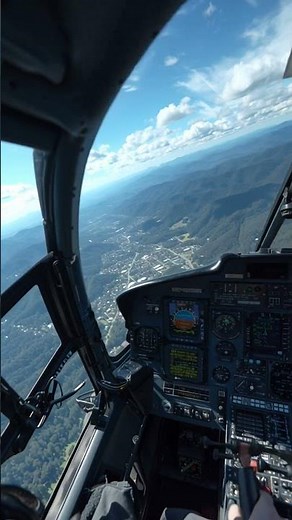inside AS350 helicopter cockpit, POV pilot view, collective lever and cyclic visible, rotor controls