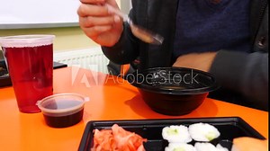 A man is eating Chinese food in a fast food restaurant. 4k. Slow motion. he eats soup from a disposable plate