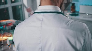 Close up hands of medical research scientists work use test tubes in modern science laboratory. Background team work. Liquid, equipment, experiment, technician, biotechnology. Slow motion