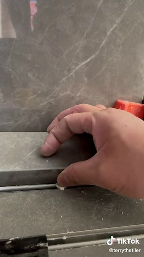 Some custom capping for shower edge with epoxyed edge #tile #tiler