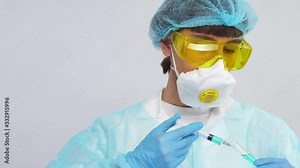 young scientist in biohazard suit taking liquid in syringe from blue test tube and pouring to air