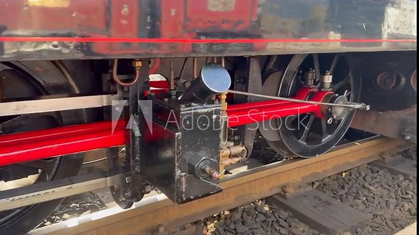 Steam train close up of wheels moving on track. Tourism transport in Wales slow motion UK 4K