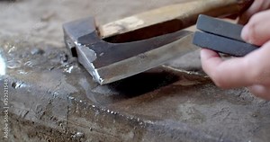 Sharpen your axe to make it look like new. Remove rust from an axe.Old ax full of rust.