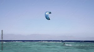 Professional kite surfer on the sea wave, athlete showing fast riding with kite and board in air. Extreme water sport and summer vacations concept